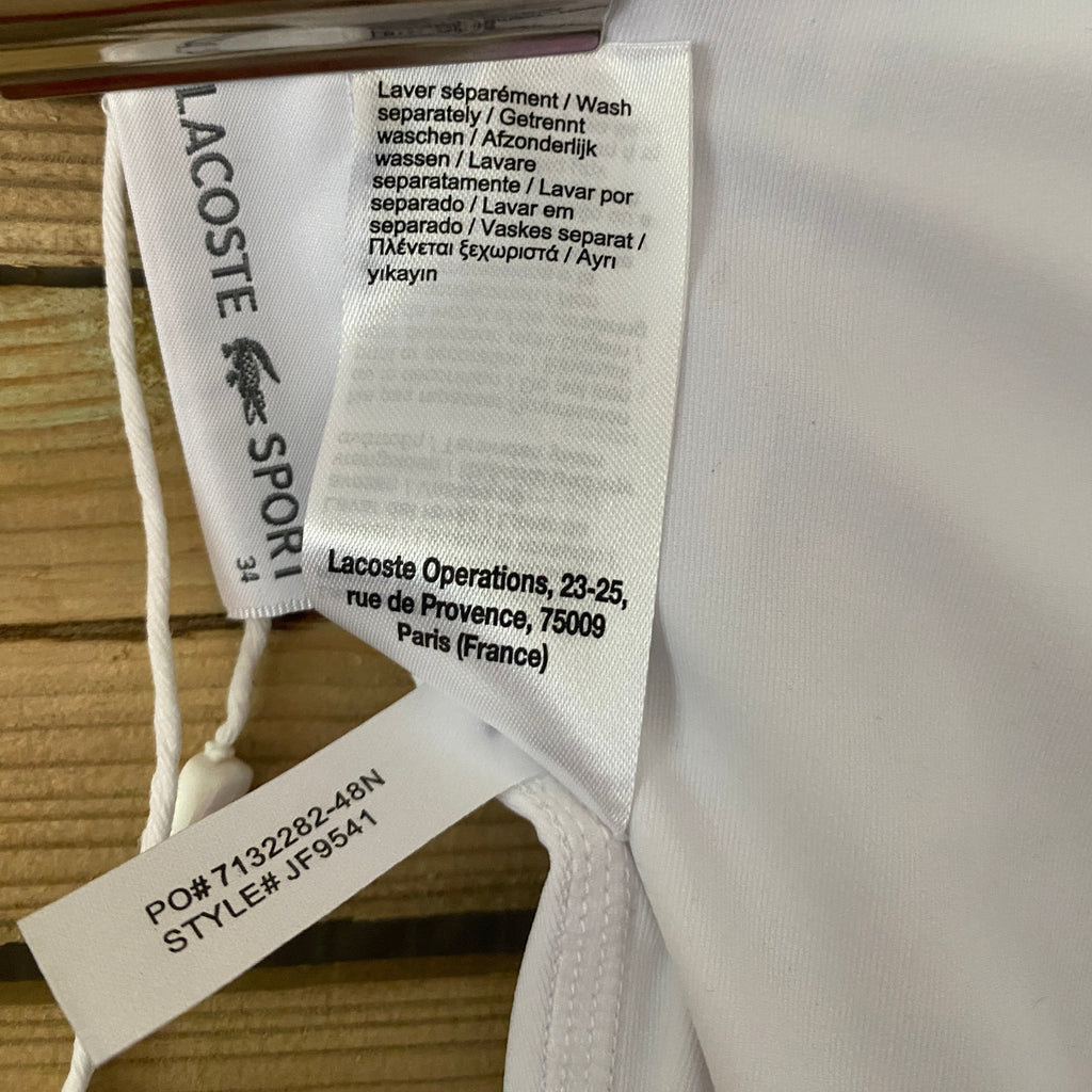 Détail étiquette composition – polyester et élasthanne