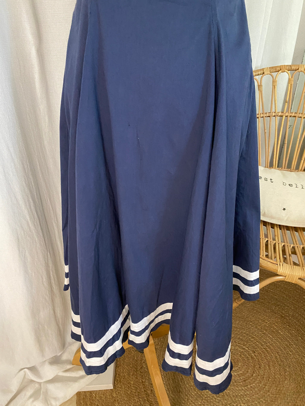 Détail jupe évasée de la robe pin up sailor Collectif, godets bleu marine, doubles bandes blanches en bordure de bas de robe