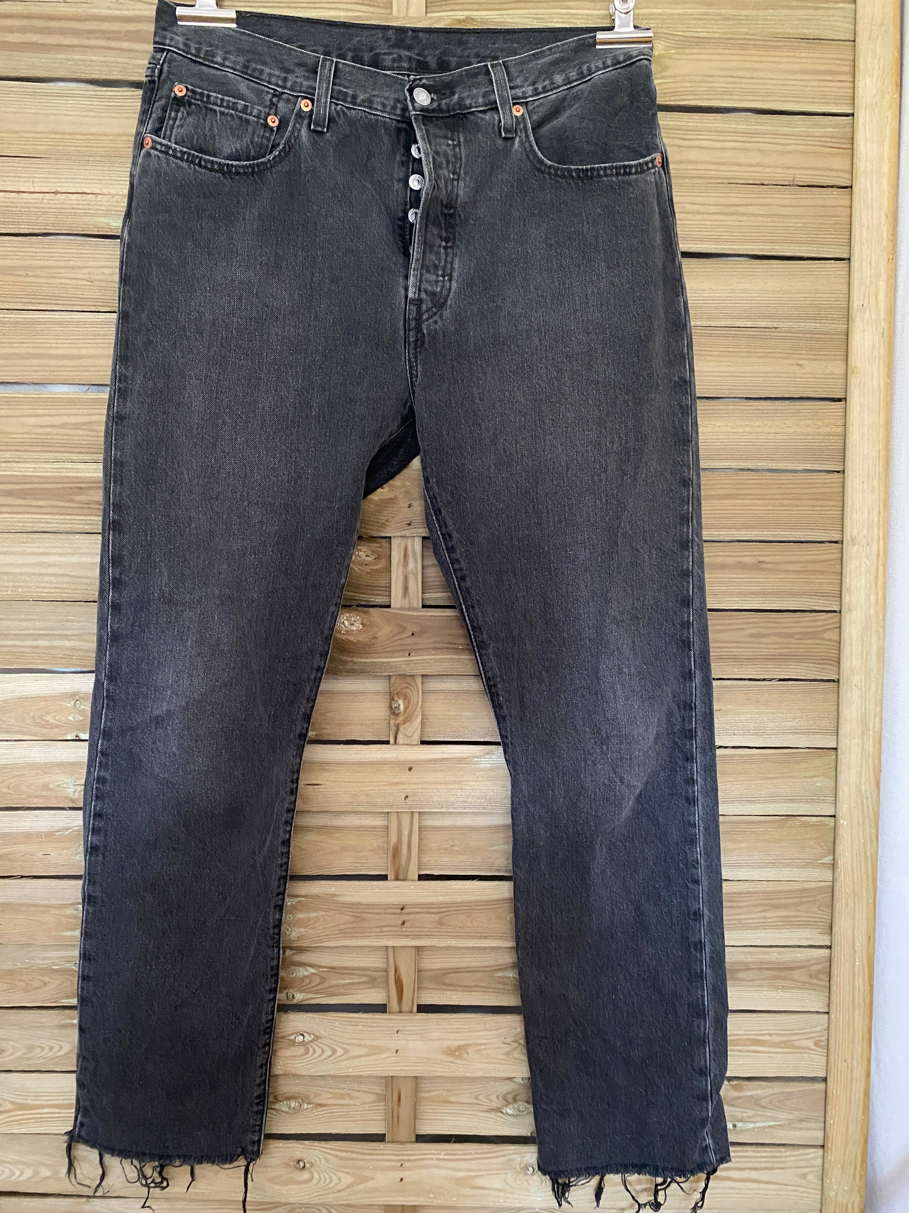 Jean vintage Levi's 501 noir délavé – vue de face globale sur cintre